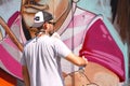 Street artist painting colorful graffiti on wall - Modern art concept with urban guy painting live murales with aerosol color spra