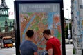 TOURISTS STUDING COPENHAGEN CITY MAP