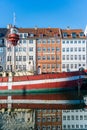 boat and houses reflected in water at Nyhavn pier, copenhagen, denmark Royalty Free Stock Photo