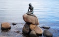 COPENHAGEN, DENMARK - MAY 31, 2017: The bronze statue of the Little Mermaid, Den lille Havfrue, on the coastal rocks by the waters Royalty Free Stock Photo