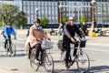 People riding bicycles in helmets, Copenhagen, Denmark. Street style Royalty Free Stock Photo