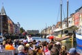 Copenhagen, Denmark- May 30, 2023: Nyhavn pier, colorful view from canal tour boat with many people