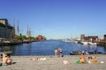 Copenhagen, Denmark- May 30, 2023: people relax on a wooden terrace on the harbor embankment