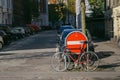 Copenhagen, Denmark- May 6, 2018: Red bike parked on city street near car parking and No Entry sign, urban background.