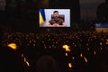 Ukrainian President Zelensky speaks via broadcast to a large crowd of people