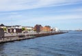 View of waterfront of Copenhagen, Denmark. Old houses with tiled roofs and sailing ship on a sunny summer day. Royalty Free Stock Photo