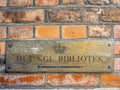 Weathered brass plate showing direction to the Royal Library Bibliotek Royalty Free Stock Photo