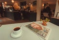 Breakfast with black coffee wand morning newspaper inside city cafe