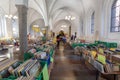 Old church hall with flea market of antique books and many reading customeres