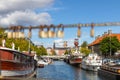 Love locks on the bridge and blurred housesin and boats in the background. Copenhagen, Denmark