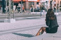 Copenhagen, Denmark - September 14, 2019. A woman drinking Green Tuborg on a sidewalk of Copenhagen`s downtown next to Burger King