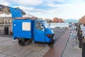 Three-wheeled mini truck parked near the sea pier Royalty Free Stock Photo