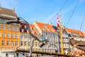 Copenhagen iconic view. Famous old Nyhavn port in the center of Copenhagen, Denmark during summer sunny day with a bicycle Royalty Free Stock Photo