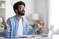 Coping With Working Stress. Smiling Calm Indian Man Meditating At Home Office Royalty Free Stock Photo