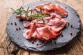 Coppa di Parma ham on slate board with rosemary salt and pepper Royalty Free Stock Photo