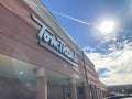 Logo at entrance of Tom Thumb grocery store under cloud blue sky