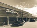 Filtered tone entrance of Tom Thumb grocery store under cloud bl