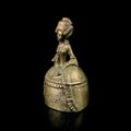 Copper antique bell in the shape of a girl in a magnificent dress.