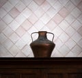 Copper antique vase on a background of a wall of tiles. Still life