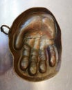 Copper ashtray in the form of a hand for receiving coins