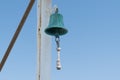 Copper bell on boat yacht on blue sky background