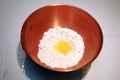 Copper bowl with flour and an egg Royalty Free Stock Photo