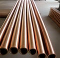 Copper bronze heat exchanger pipes. Heavy non-ferrous metallurgy. Factory industrial production of metal cuprum pipes