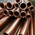 Copper bronze heat exchanger pipes. Heavy non-ferrous metallurgy. Factory industrial production of metal cuprum pipes