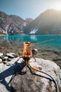 Copper Cezve for coffee in autumn lake camping in the mountains