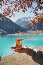 Copper Cezve for coffee in autumn lake camping in the mountains