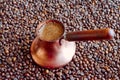 Copper cezve with freshly brewed coffee beans Royalty Free Stock Photo