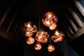 Copper colored glass pendant light fitting hanging in attic with wooden beams