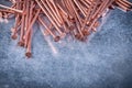 Copper construction nails on metallic background Royalty Free Stock Photo