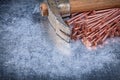 Copper construction nails vintage claw hammer on metallic backgr Royalty Free Stock Photo
