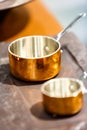 Copper cookware, pots and pans are on the counter in the store. Royalty Free Stock Photo