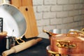 Copper cookware with wooden kitchen utensils close up Royalty Free Stock Photo