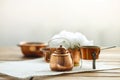 Copper old scratched vintage crockery kitchenware on the table