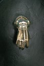 Copper door knocker in the shape of a hand