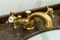 Copper faucet in hotel shower room, focus on hot water faucet