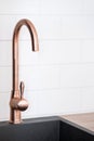 Copper faucet over black modern sink in kitchen Royalty Free Stock Photo