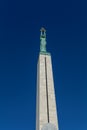 Copper figure of Liberty at the top of the Freedom Monument in Riga, Latvia