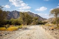 Copper Hike trail, winding gravel dirt road through Wadi Ghargur riverbed, UAE Royalty Free Stock Photo