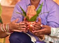 Copper Kalash with coconut in hand hindu puja