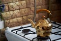 Copper kettle stands on an old vintage plate. Kitchen interior Royalty Free Stock Photo