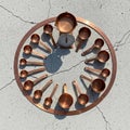 Copper measuring cups and spoons arranged in a circular pattern on a textured, Royalty Free Stock Photo