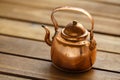 Copper old scratched vintage crockery kitchenware kettle on the table Royalty Free Stock Photo