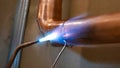 copper pipe soldering process with tin by specialized technicians Royalty Free Stock Photo