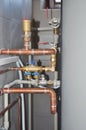 Copper pipes heating system. House heating system copper pipes. Copper pipes of solar water heater system in boiler room