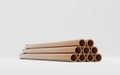 Copper pipes stack on isolated white background, hollow cylinder steel metal or pvc plumbing, glossy bronze tube set Royalty Free Stock Photo