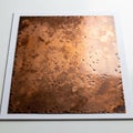 Copper plate with a weathered, oxidized surface showing dark spots and Royalty Free Stock Photo